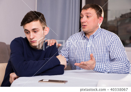 Boy is offended and father is asking for his forgiveness Boy is offended and father is asking for his forgiveness 40338067