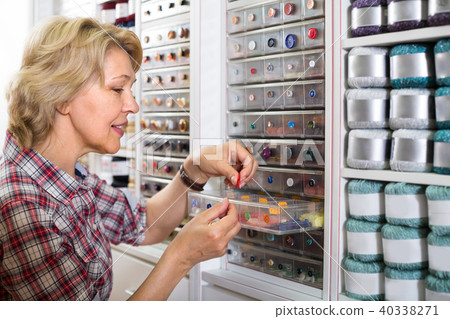 mature woman in sewing store. 40338271