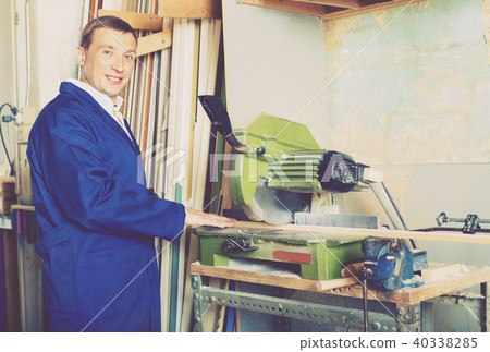 Man operating circular saw in wood workshop Man operating circular saw in wood workshop 40338285