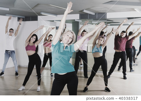 adults of different ages dancing at dance class 40338317