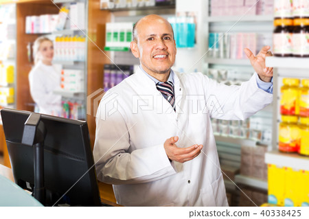 Pharmacist and assistant working at farmacy reception Pharmacist and assistant working at farmacy reception 40338425