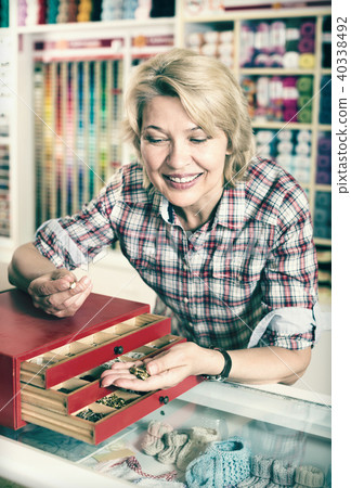 Female next to box with metallic fasteners 40338492