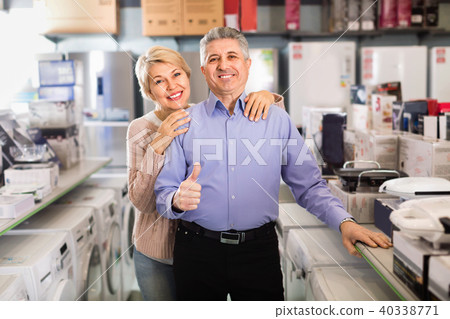 Husband and the wife are satisfied with wide range of household appliances 40338771