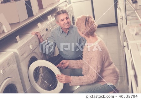 Mature smiling couple choosing home washing machine 40338794