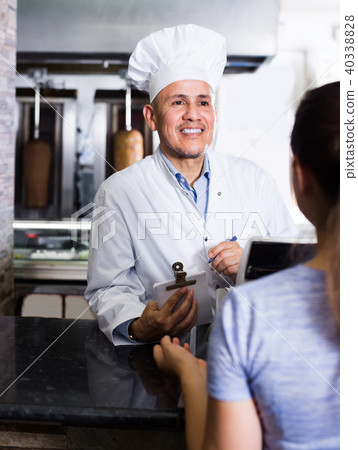 Mature man cook taking order from customer in cafe 40338828