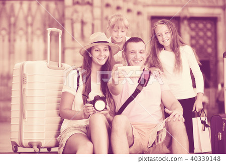 Active parents with two kids taking selfie 40339148