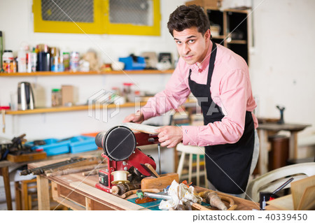 Carpenter working on manual lathe 40339450