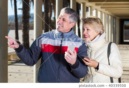 Glad mature couple walking and make selfie Glad mature couple walking and make selfie 40339508