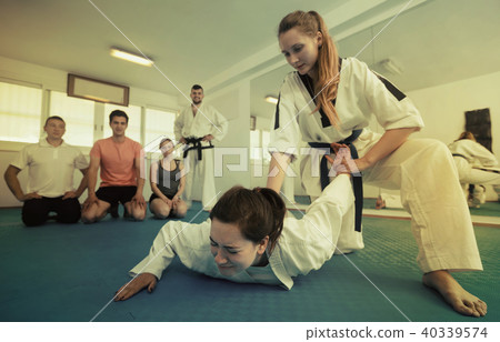Female coach showing painful hold Female coach showing painful hold 40339574