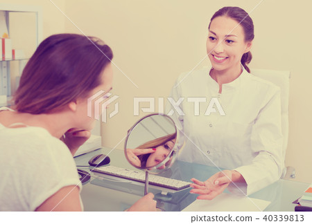 Woman client checking result of beauty procedures 40339813