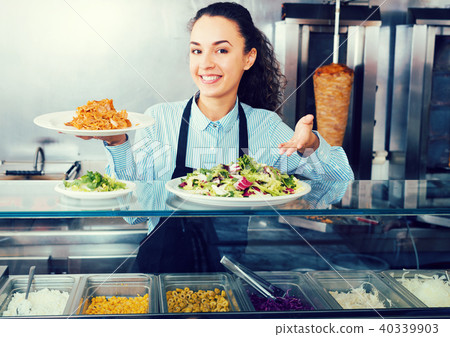 Smiling brunette girl with kebab and vegetables 40339903