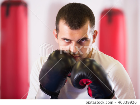 young sportsman in the boxing hall practicing boxing punches 40339926
