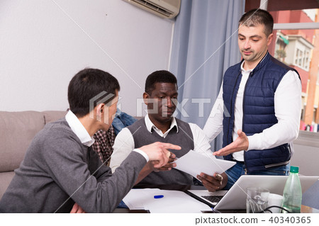 Serious males with documents at home 40340365