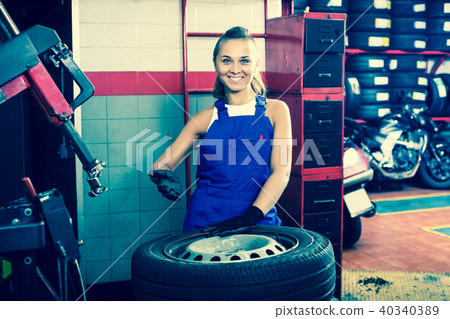 Mechanic working on car wheel Mechanic working on car wheel 40340389