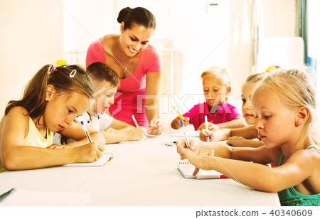 Kids learning to write on lesson in elementary school class 40340609