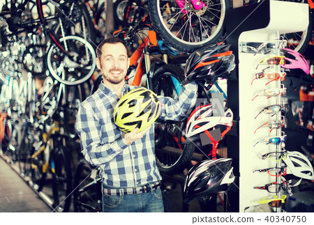 Man considering the range of helmets 40340750