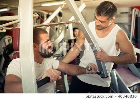 Guy with trainer in gym Guy with trainer in gym 40340830