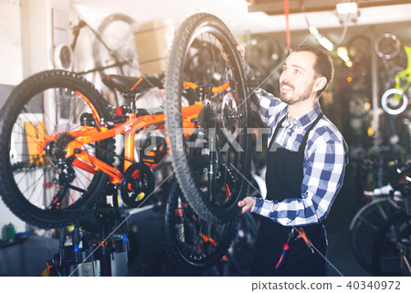 Worker with bicycle wheel Worker with bicycle wheel 40340972