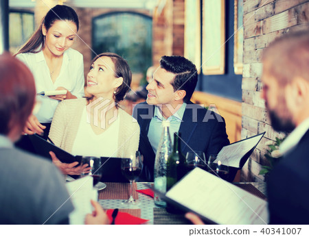 girl the waiter recommends dishes to guests 40341007