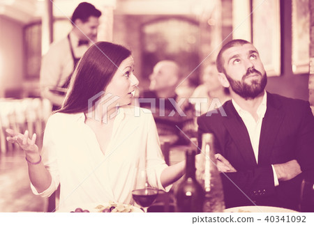 quarreled visitors female and male in restaurant 40341092