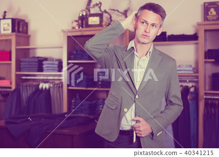 Shopper is trying on new emerald jacket 40341215