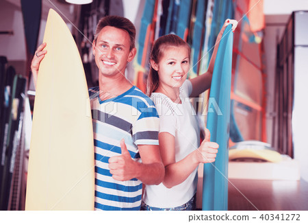 Portrait of happy couple standing with new surfboards 40341272