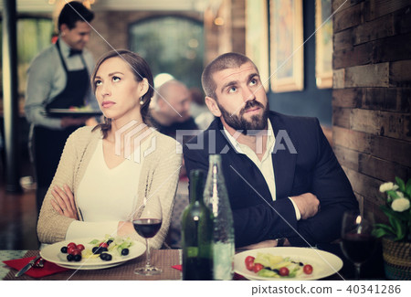 Portrait of upset man and woman in the restaurant on meeting Portrait of upset man and woman in the restaurant on meeting 40341286
