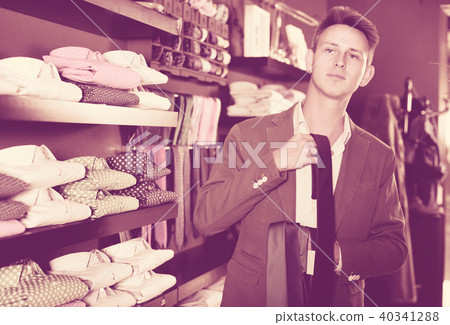 Guy deciding on new tie Guy deciding on new tie 40341288