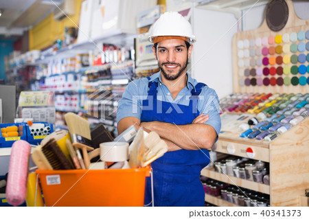 Workman standing folded arms near basket with picked tools in pa Workman standing folded arms near basket with picked tools in pa 40341373