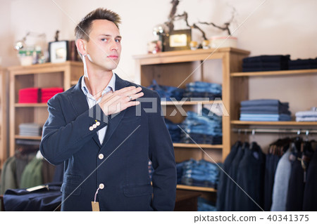 Customer examining suits Customer examining suits 40341375