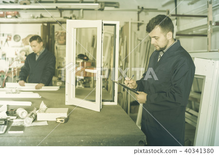 Workman showing PVC manufacturing output Workman showing PVC manufacturing output 40341380