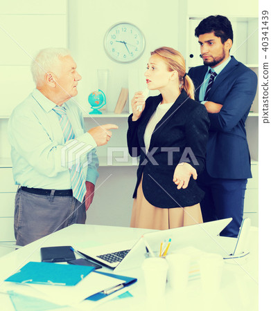 Mature boss is chastising employees because of uncompleted work Mature boss is chastising employees because of uncompleted work 40341439