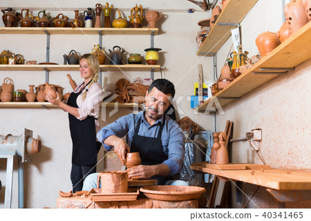 Workers in ceramics studio with pottery wheel Workers in ceramics studio with pottery wheel 40341465