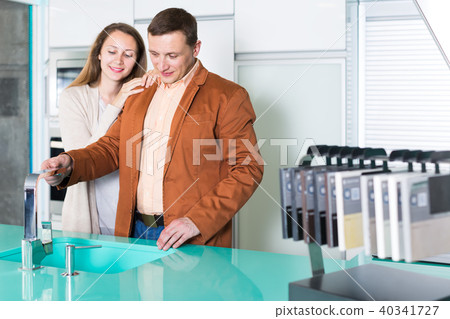 Happy couple customers choosing tabletop Happy couple customers choosing tabletop 40341727