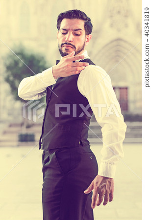 Smartly dressed man shaking dust off shoulder 40341819