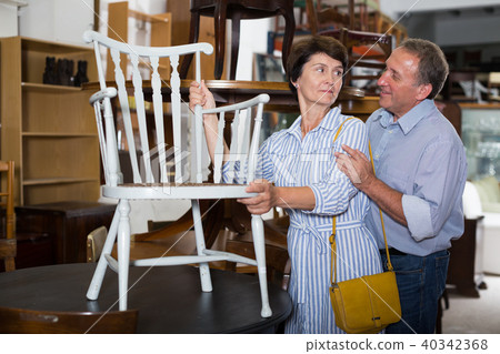 Mature couple is choosing the antique armchair 40342368