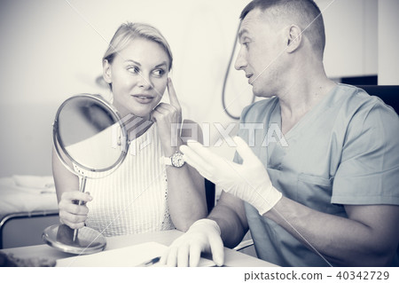 Woman is talking with specialist about halthy of skin of face Woman is talking with specialist about halthy of skin of face 40342729