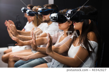 Woman watching exciting movie with VR glasses Woman watching exciting movie with VR glasses 40342827