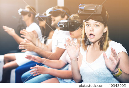 Portrait of frightened young girl after watching of exciting movie with VR glasses Portrait of frightened young girl after watching of exciting movie with VR glasses 40342905