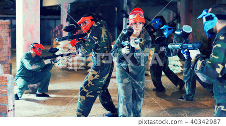 Young people playing paintball 40342987