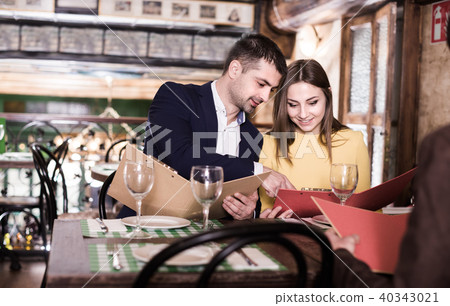 Couple is choosing order for dinner Couple is choosing order for dinner 40343021