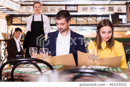 Couple is choosing order for dinner Couple is choosing order for dinner 40343032