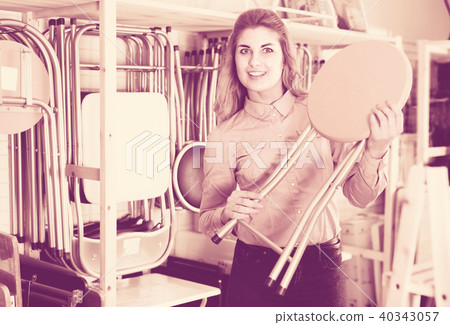 Smiling woman looking for new stylish tabouret 40343057
