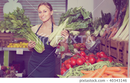 woman selling fresh greens on market 40343146