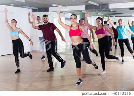 Group of active people training dance in studio 40343156