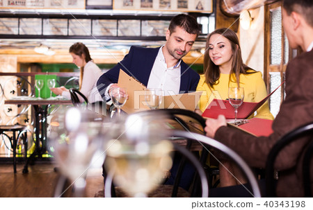 Couple is choosing order for dinner Couple is choosing order for dinner 40343198