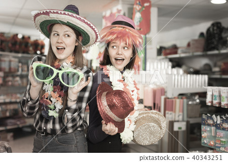 Female friends having fun in festival outfits store Female friends having fun in festival outfits store 40343251