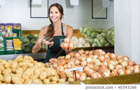 portrait of woman in apron selling unpeeled onions portrait of woman in apron selling unpeeled onions 40343266