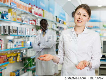 female pharmacist inviting to drugstore female pharmacist inviting to drugstore 40343267