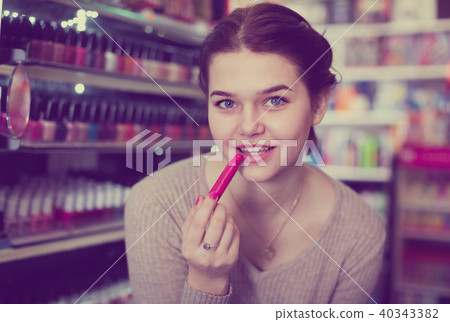 Smiling female looking for make-up items 40343382